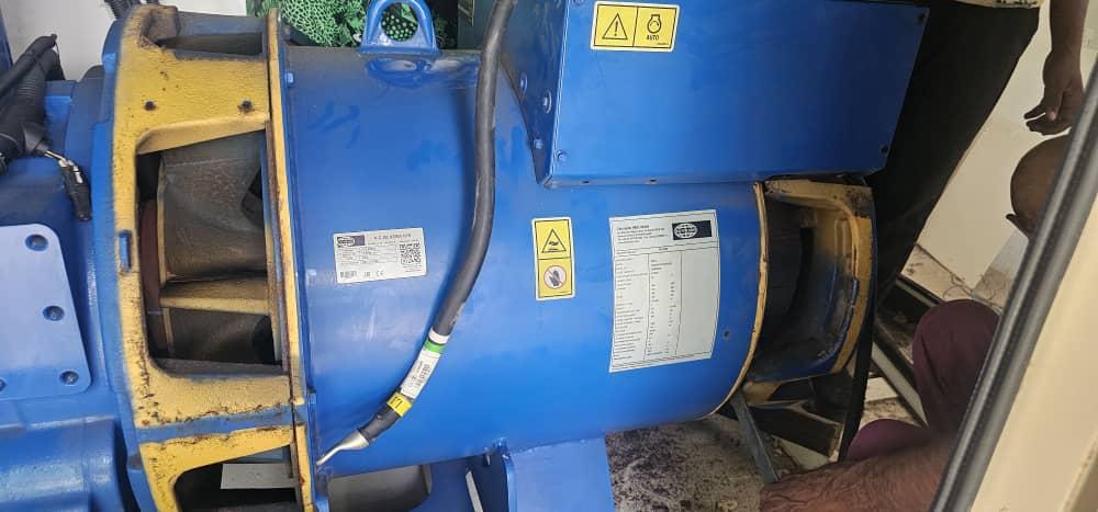 Blue industrial generator and alternator on site