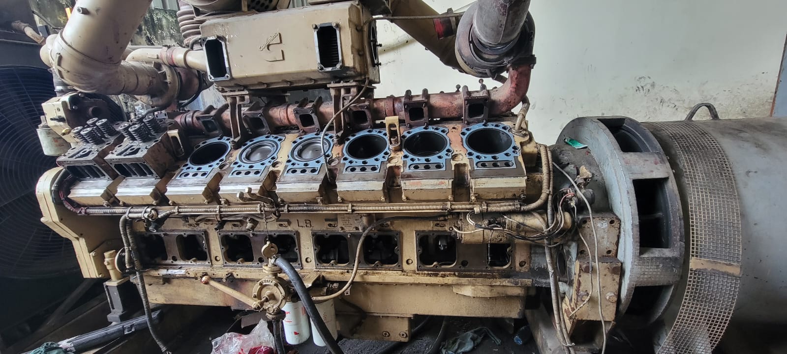 Marine generator engine with cylinder heads removed during overhaul