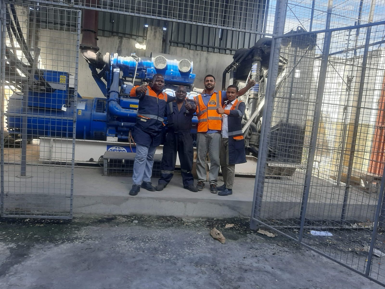 Haji General team on site in front of industrial generator